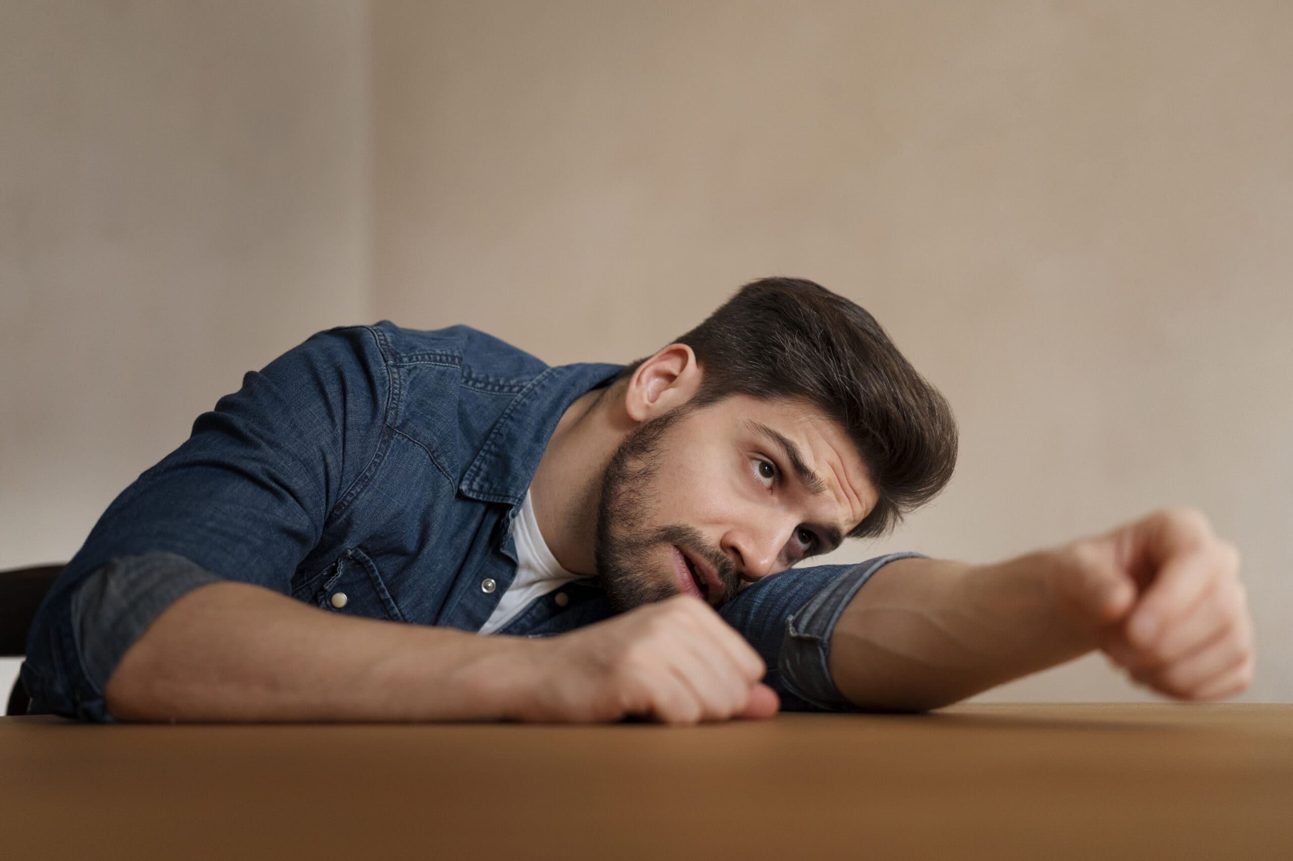 Anxious young man thinking about therapy for generalized anxiety disorder
