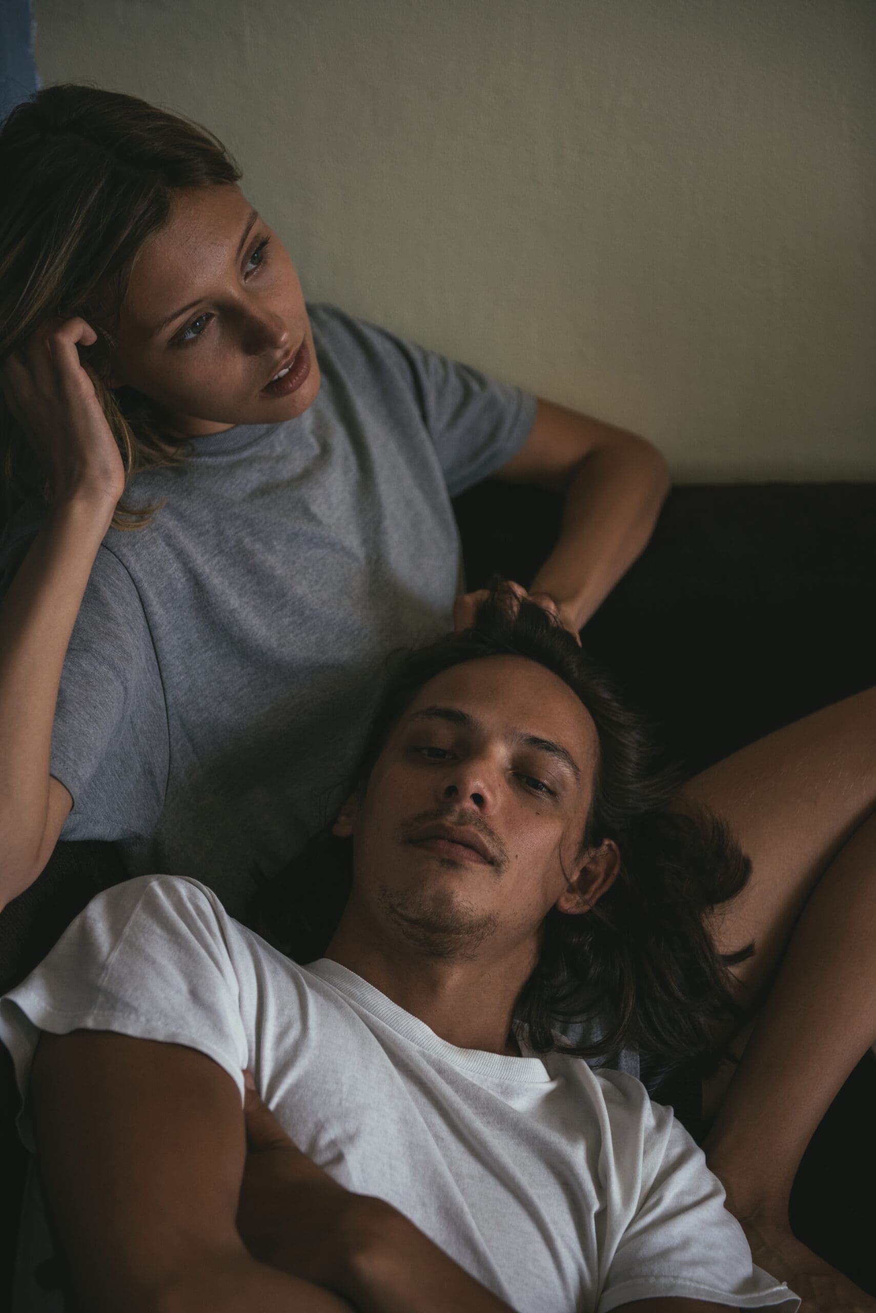A young couple lying down talking and venting to reduce stress