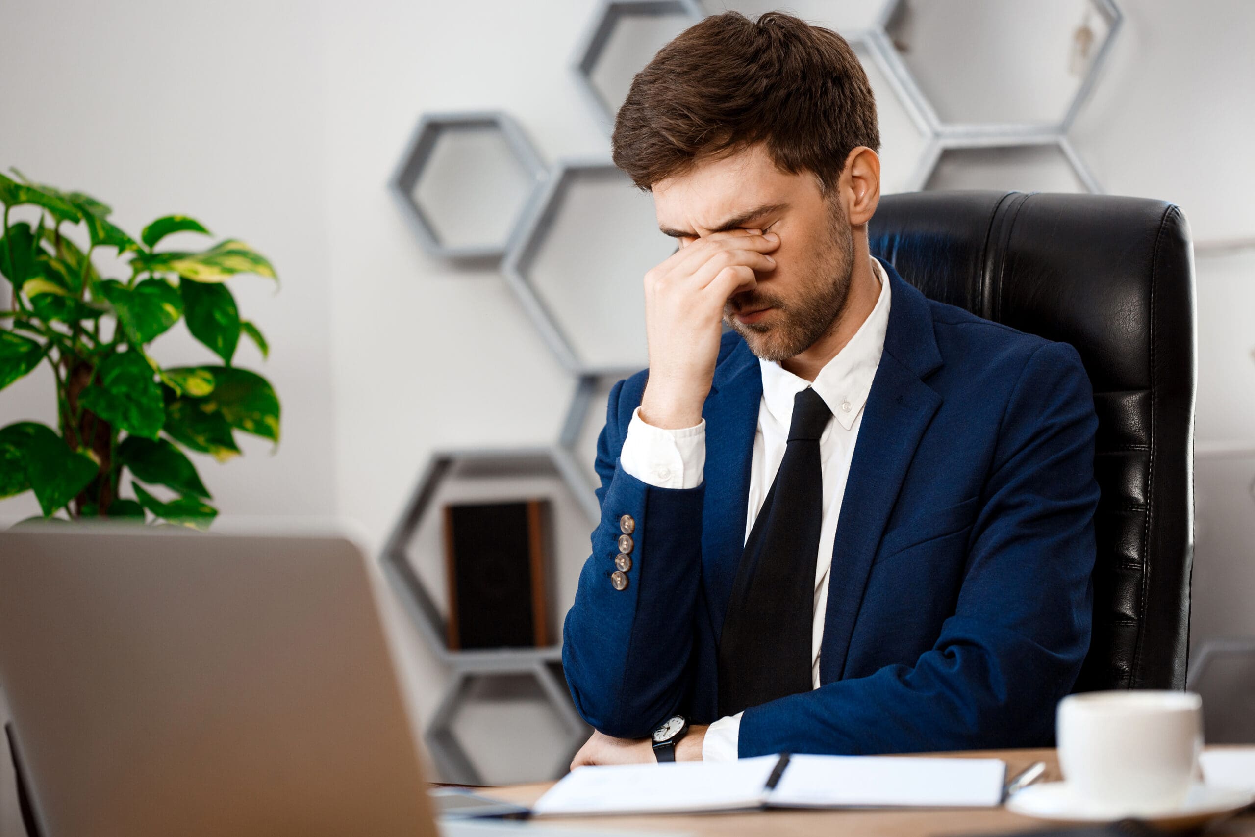 Young businessman struggling with high-functioning anxiety at work