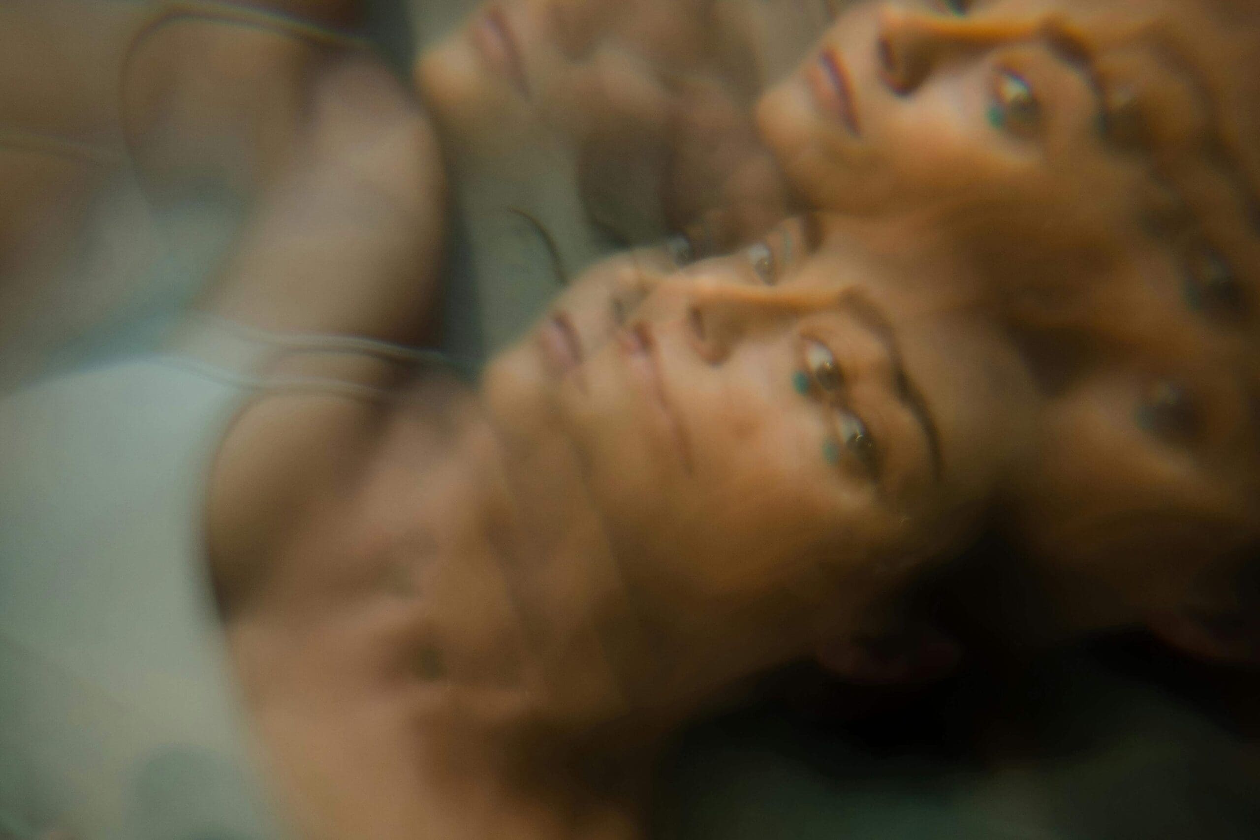 Young woman laying down wondering what are defense mechanisms