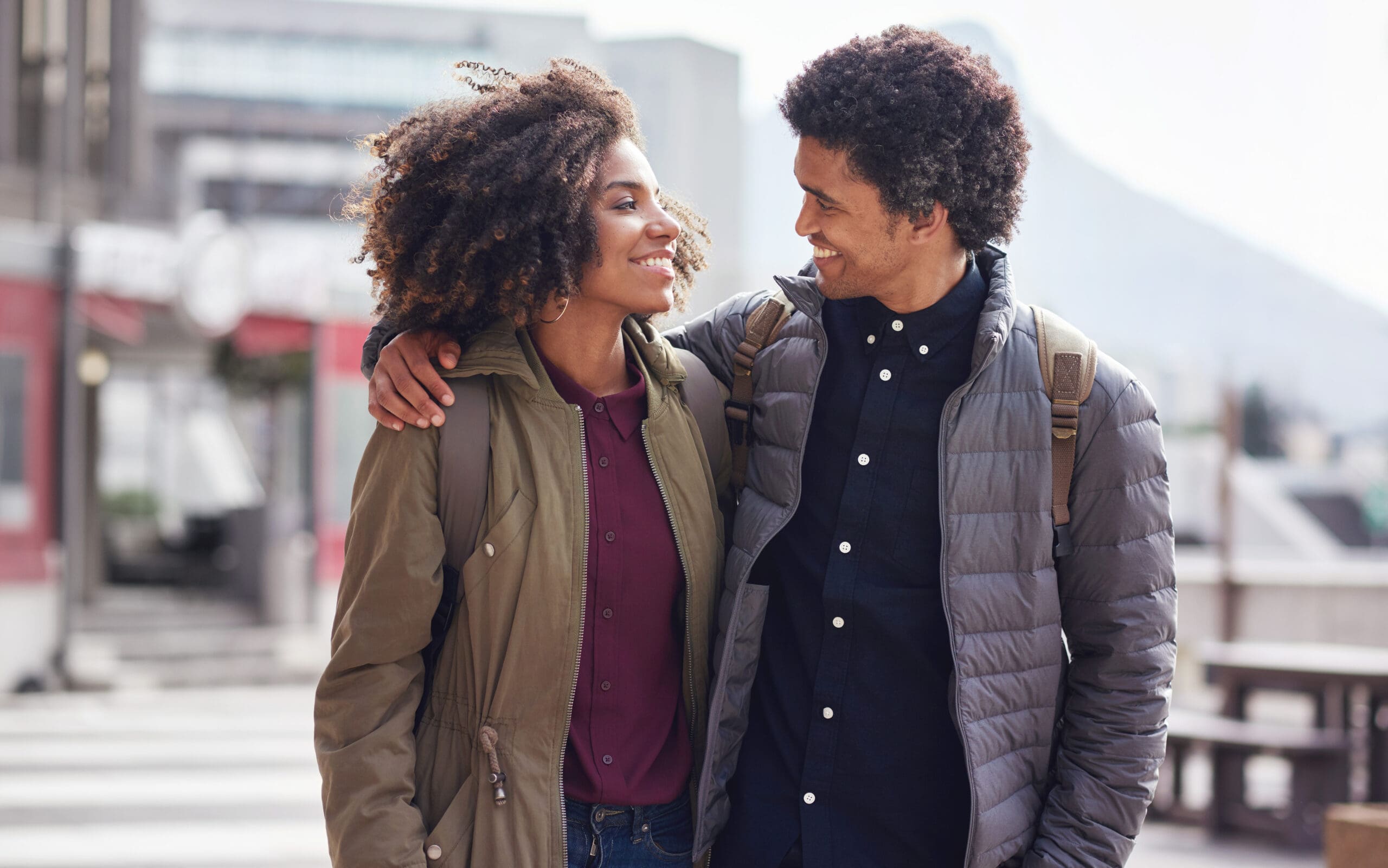 Happy dating couple walking together in person